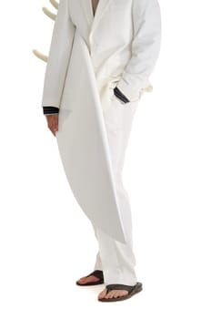 Man in white suit holding surfboard