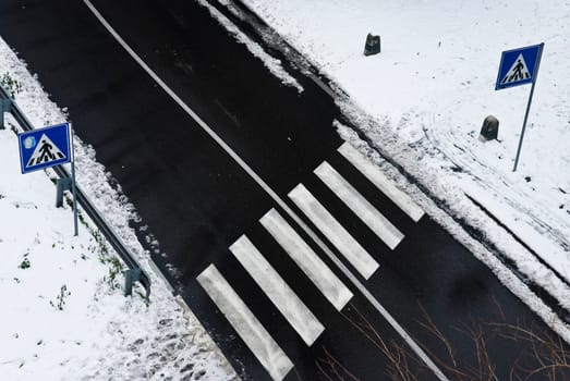 Snowy empty zebra cross shot from above
