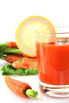a glass of carrot juice with fresh ingredients