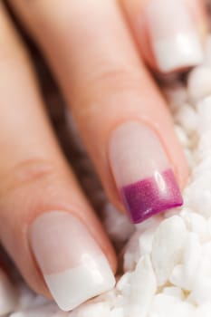 Female colorful clean fingernails in white and violet