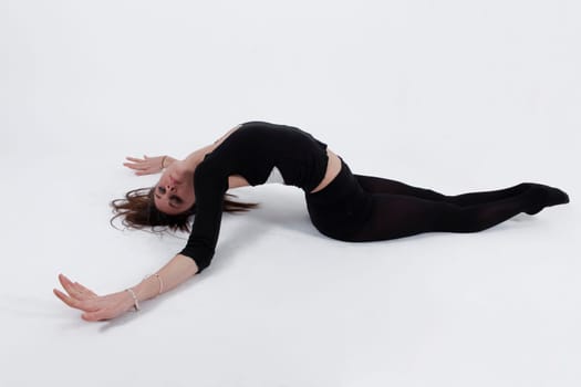 Young gymnast in black on studio practice