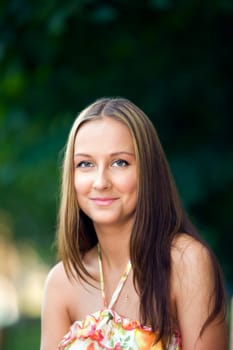 Young beautiful woman in nature background