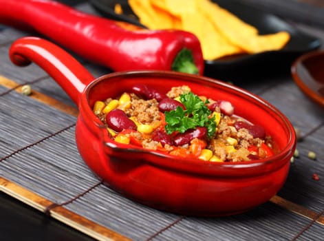 Bowl of chili with peppers and beans