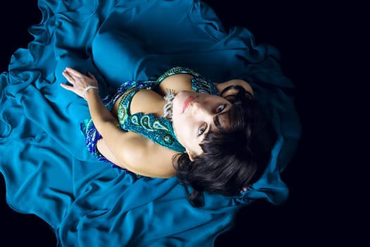 woman in blue costume look at you