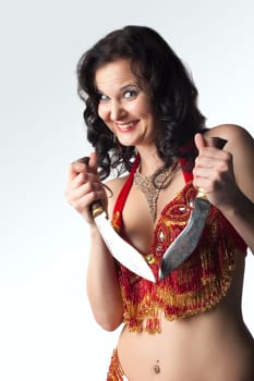 Insane smiling  woman in arabian costume with knife