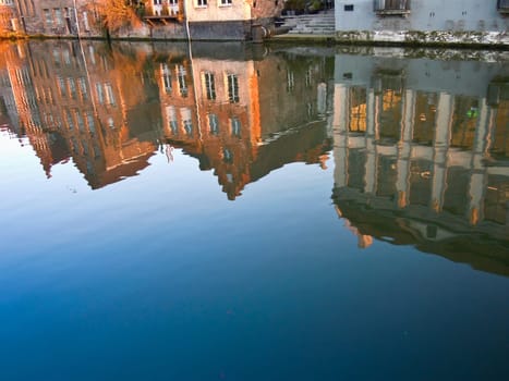 Houses reflected in the river Leie in the Belgian city of Ghent