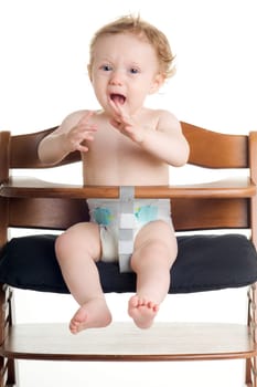 Hungry karate baby in dining chair with white background