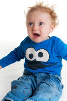 Crying sad baby with blue t-shirt