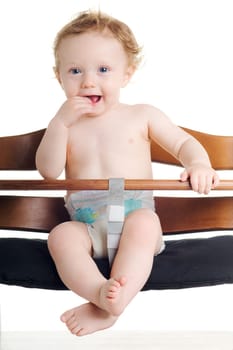 Cute hungry baby in dining chair with white background