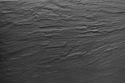 Dark grey / black slate background or texture.