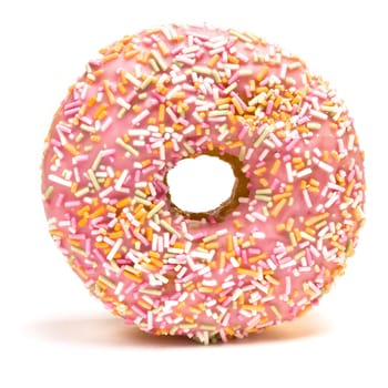 Pink Iced Doughnut covered in sprinkles isolated against white background.