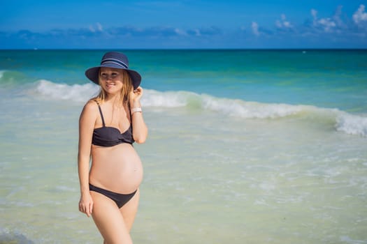 Radiant pregnant woman in a swimsuit, amid the stunning backdrop of a turquoise sea. Serene beauty of maternity by the shore.