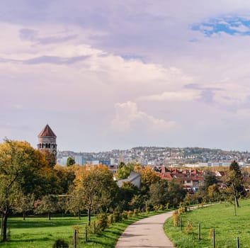 Germany, Stuttgart panorama view. Beautiful houses in autumn, Sky and nature landscape. Vineyards in Stuttgart - colorful wine growing region in the south of Germany with view over Neckar Valley. Germany, Stuttgart city panorama view above vineyards, industry, houses, streets, stadium and highway at sunset in warm orange light.