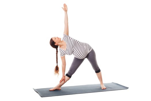 Pregnancy yoga exercise - pregnant woman doing asana Utthita trikonasana - extended triangle pose easy variation isolated on white background