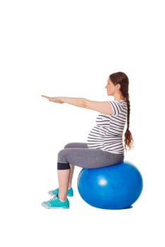 Pregnancy exercise concept - pregnant woman doing exercises with exercise ball isolated on white background