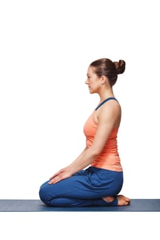 Woman in Hatha yoga asana Vajrasana - vajra pose or diamond pose