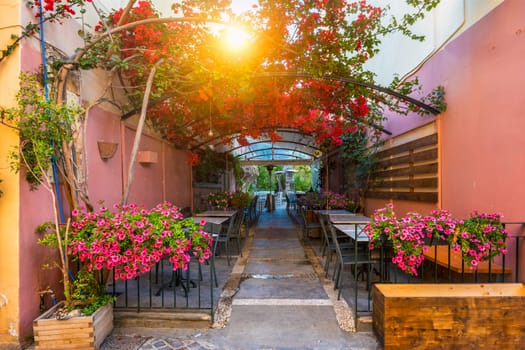 Street cafe in scenic picturesque streets of Chania venetian town with coloful old houses. Chania greek village in the morning. Chanica, Crete island, Greece