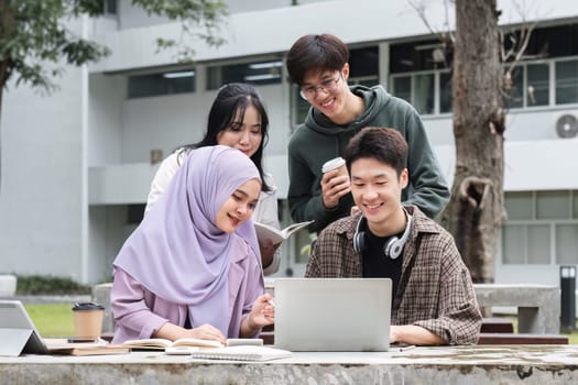 A multiracial group of students at the college, including Muslim and Asian students, sat on benches in a campus break area. Read books or study for exams together..