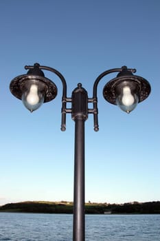 irish street light isolated on blue sky and sea background with clipping path