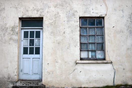 an old decaying house front door and window in ireland