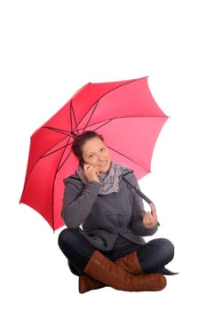 Young woman with mobile phone and umbrella