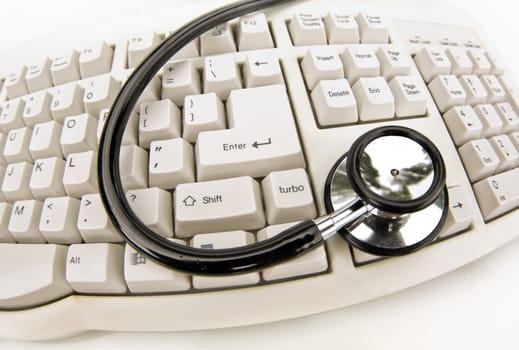 medical technology or computer problems stethoscope and keyboard on white