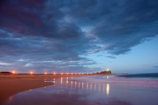 breakwater or jetty leading to lighthouse at night