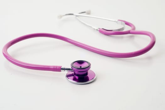 great image of pink stethoscope on white