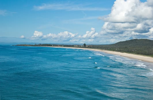 the long curving beach of a tropical coastline