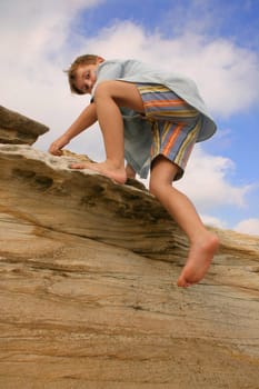 Child clambering climbing over coastal rocks  CAMERA INFO: Camera Model Name     Canon EOS 300D DIGITAL Shooting Date/Time     20/03/2004 4:28:36 PM Shooting Mode     Program AE Tv( Shutter Speed )     1/200 Av( Aperture Value )     8.0 Meter