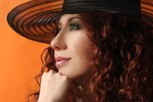 Stylised woman wearing a black large brimmed hat
