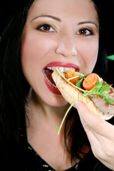 A woman eating a healthy lunch.  Closeup