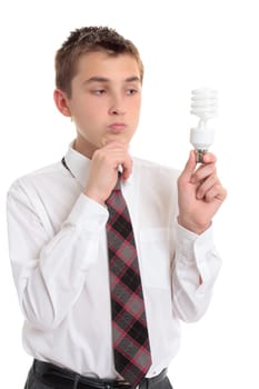 Brainstorming school student holds an eco friendly fluorescent light bulb - in need of ideas