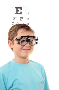 A boy with trial frames during a visit to the eye doctor