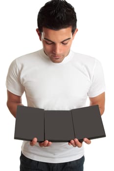 A man shows, markets a set of DVD&#039 s ready for your designs.  He is holding each dvd side by side and looking down at them.  Eg movies, games, entertainment.  Or you could replace another object eg sign, brochure, in his hands.