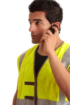 Male tradesman, handyman, builder or other labourer occupation is talking on a mobile phone.