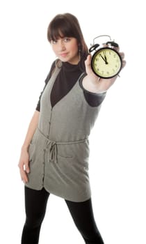 Pretty brunette girl showing alarm clock  only clock is in focus