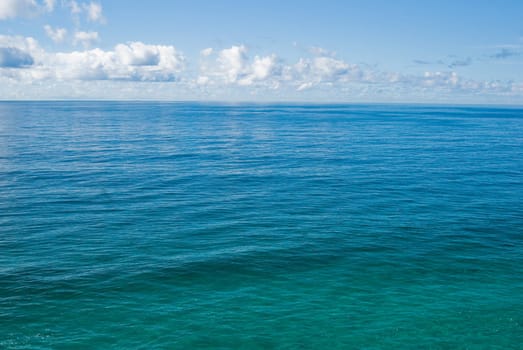 the flat and calm deep blue tropical ocean