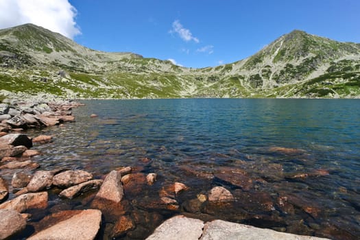 redhead stones on a blue mountain lake