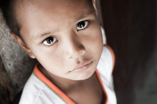 Portrait of a Filipino boy living in poverty - natural light - Manila, Philippines.