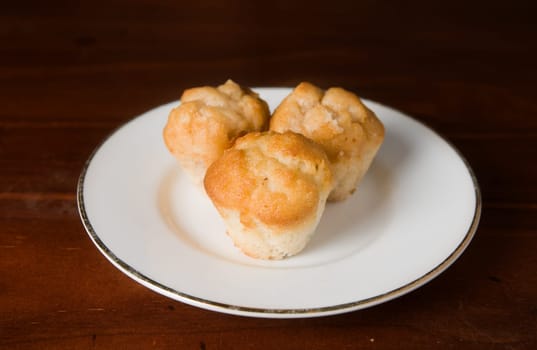 three small muffin cakes on a plate