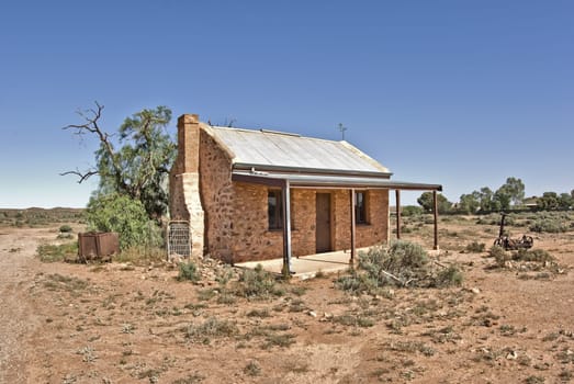 an old building going to ruins in desert at silverton