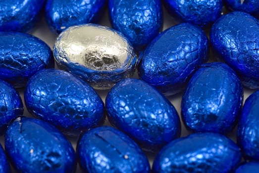 lots of blue easter eggs with one silver