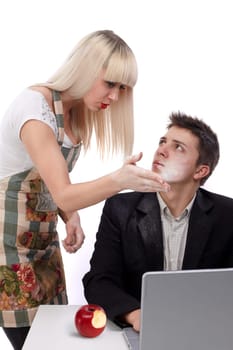 Young wife arguing with her husband because she&#039 s working and his sitting at the laptop. He bit also from the forbidden fruit. Concept of the apple of discord.