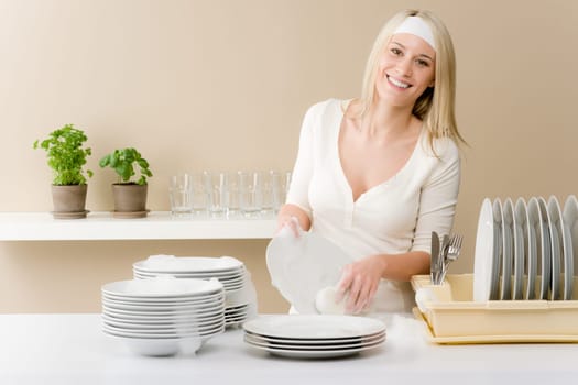 Modern kitchen - happy woman washing dishes, housework