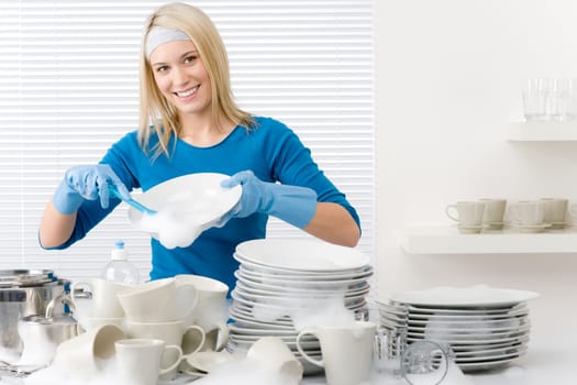 Modern kitchen - happy woman washing dishes, housework
