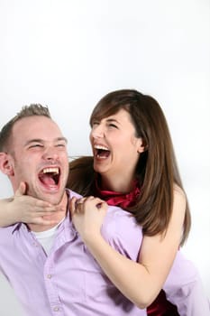 Young couple laughing themselves to death - both laughing from the bottom of their hearts