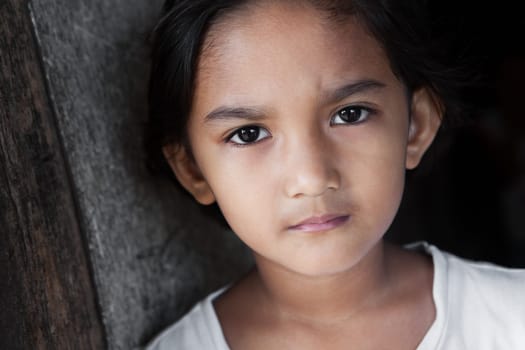 Portrait of a Filipina - young girl from the Philippines against grunge background in natural light