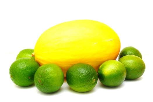 Yellow melon with green laime isolated on white