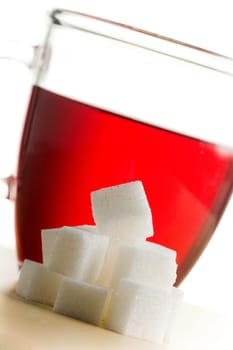 Transparent tea cup with a lot of sugar